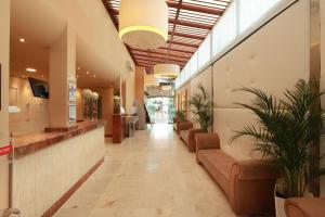 lobby szpitala z kanapami i roślinami w obiekcie Grupotel Playa Feliz w mieście San Agustin