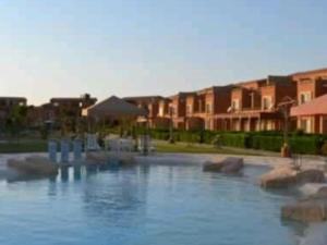 a pool of water in front of some buildings at Marina Wadi Degla Villa Duplex 4 Bedrooms in Ain Sokhna