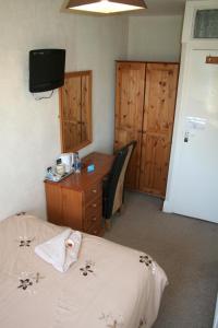 A bed or beds in a room at The Haldon Guest House