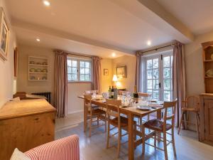 a kitchen and dining room with a table and chairs at Church Cottage in Burford