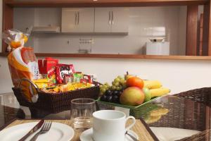 
a table topped with a plate of fruit and a cup of coffee at KS Residence in Rio de Janeiro
