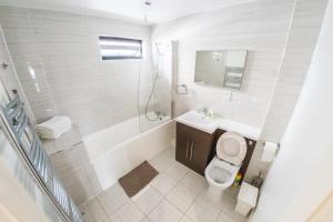 a bathroom with a toilet and a sink and a shower at Ilford Tower Apartments in Ilford