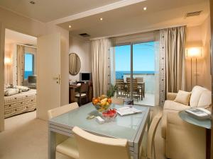 a living room with a table and a room with a view at Hotel Sarti in Riccione
