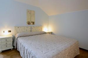 a bedroom with a bed and two night stands at Hotel Risi in Colico