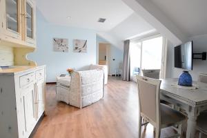 a kitchen and living room with a table and chairs at Hotel Risi in Colico