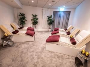 a room with three white couches in a room at Midlands Park Hotel in Portlaoise