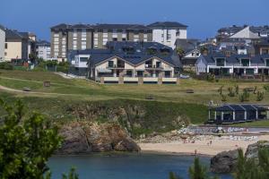 タピア・デ・カサリエゴにあるApartamentos Turísticos Playa de Tapiaの建物を背景にビーチを望む