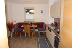 a kitchen with a table and chairs in a kitchen at Haus Markus in Fügen