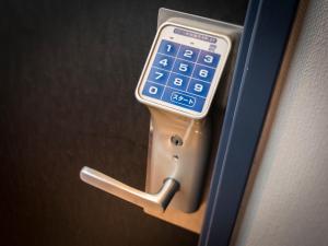 a cell phone is attached to a door handle at Super Hotel Tokyo Akabane in Tokyo