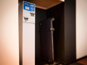 a refrigerator in a room with a sign on it at Super Hotel Tokyo Akabane in Tokyo