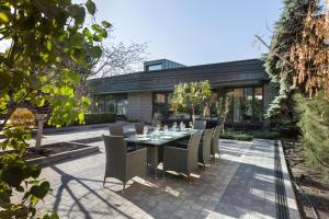 a dining table and chairs on a patio at Villa Four Rooms in Kharkiv