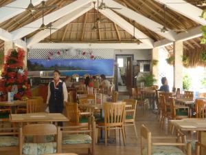 a woman standing in the dining room of a restaurant at Costa Azul Suites 905 in Santa Marta +61 photos