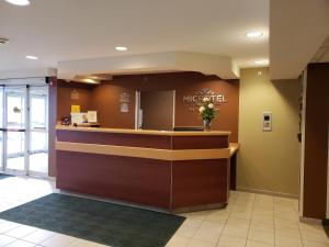 a lobby with a reception counter in a hospital at Microtel Inn & Suites Dover by Wyndham in Dover