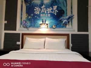 古晉的住宿－兆豐旅館，卧室配有一张壁挂式海报的床