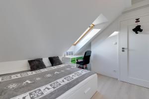 a white bedroom with a bed and a desk at "Over the Rainbow" - Lovely house close to the Beach in Gdańsk