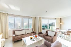 a living room with couches and a table at Dragut Point South Hotel-All Inclusive in Turgutreis