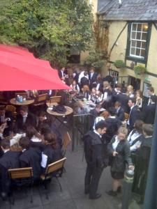 a crowd of people sitting at tables outside a restaurant at Bath Place Hotel in Oxford