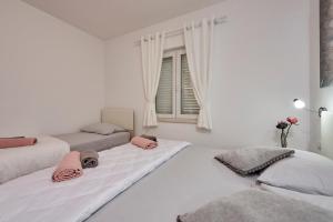 Posteľ alebo postele v izbe v ubytovaní Apartments Proto