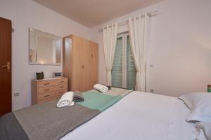 Posteľ alebo postele v izbe v ubytovaní Apartments Proto