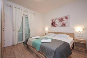Posteľ alebo postele v izbe v ubytovaní Apartments Proto