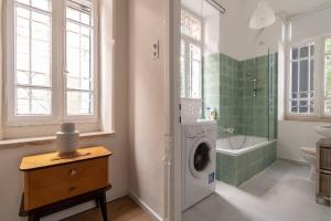 a bathroom with a washing machine and a sink at The Pearl in Talbyeh in Jerusalem +15 photos