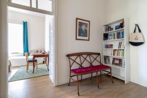 a living room with a chair and a book shelf at The Pearl in Talbyeh in Jerusalem