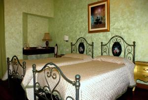 a bedroom with a bed and a table and a mirror at La Portella in Fabriano