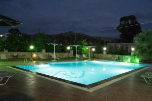 a large swimming pool at night at Dimitris Villa Hotel in Matala