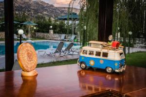 a toy van sitting on a table next to a pool at Dimitris Villa Hotel in Matala