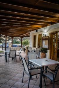 a group of tables and chairs on a patio at Dimitris Villa Hotel in Matala