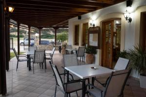 a patio with tables and chairs in a restaurant at Dimitris Villa Hotel in Matala