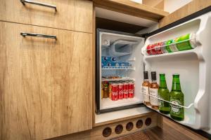 an open refrigerator filled with lots of drinks at Venice Boutique Aparthotel in Braşov