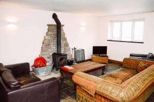 a living room with two couches and a fireplace at The Bike Shed in New Mills