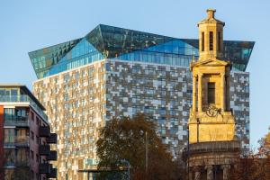 a tall building with a clock tower in front of it at City Centre Penthouse in Birmingham