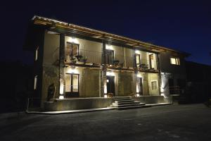a lit up building with stairs outside at night at Agriturismo Ai Prüsot in Bagnolo Piemonte