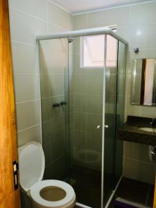 a bathroom with a toilet and a glass shower at POUSADA TAQUARAS in Cassino +31 photos
