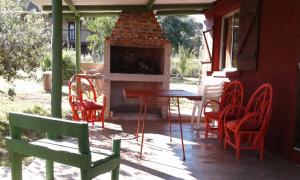 un patio con mesa, sillas y chimenea en Casa de Amelia (Punta Rubia), en La Pedrera
