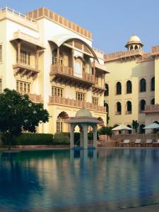 - un grand bâtiment avec une piscine en face dans l'établissement Taj Hari Mahal Jodhpur, à Jodhpur