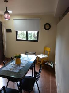 a dining room with a table and chairs and a clock at ZUHAUSE in Puerto Iguazú