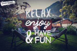 a sign that says relax enjoy and have fun at Great Hostels Backpackers in Baños