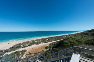 a view of the beach from the top of a bluff at Sand n Sun Beach House in Guilderton