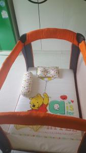 a childs crib with a winnie the pooh bed at Donchai House in Chiang Mai