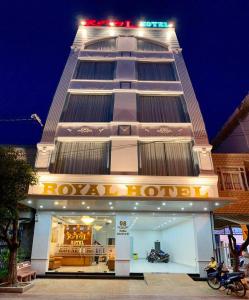 a tall building with a store in front of it at Royal Hotel in Bạc Liêu