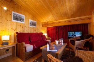 a living room with a couch and a table at Le Chalet au Tour ski in-ski out - Happy Rentals in Chamonix