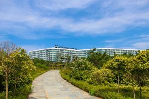 a building with a road in front of it at Wyndham Grand Qingdao in Huangdao