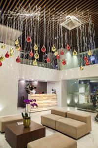 a lobby with christmas ornaments hanging from the ceiling at Ramada Encore by Wyndham Makati in Manila