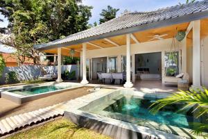 a swimming pool in the backyard of a house at Lilin Lovina Beach Hotel in Lovina