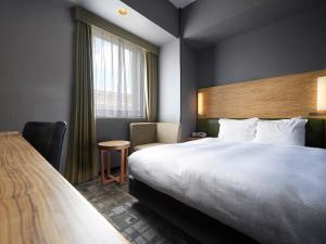 Postel nebo postele na pokoji v ubytování Sotetsu Grand Fresa Tokyo-Bay Ariake