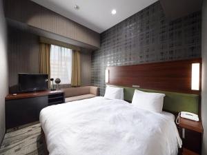 Postel nebo postele na pokoji v ubytování Sotetsu Grand Fresa Tokyo-Bay Ariake