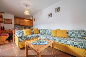 a living room with a couch and a table at Martina Ski in - Ski out Mt 50 - Happy Rentals in Livigno